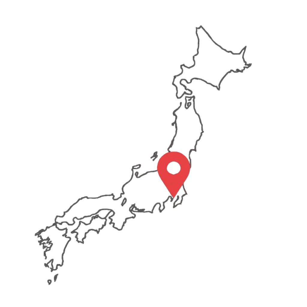 "Outline map of Japan with a red location pin near central Honshu, displayed on a dark background in minimalist grey-line style."