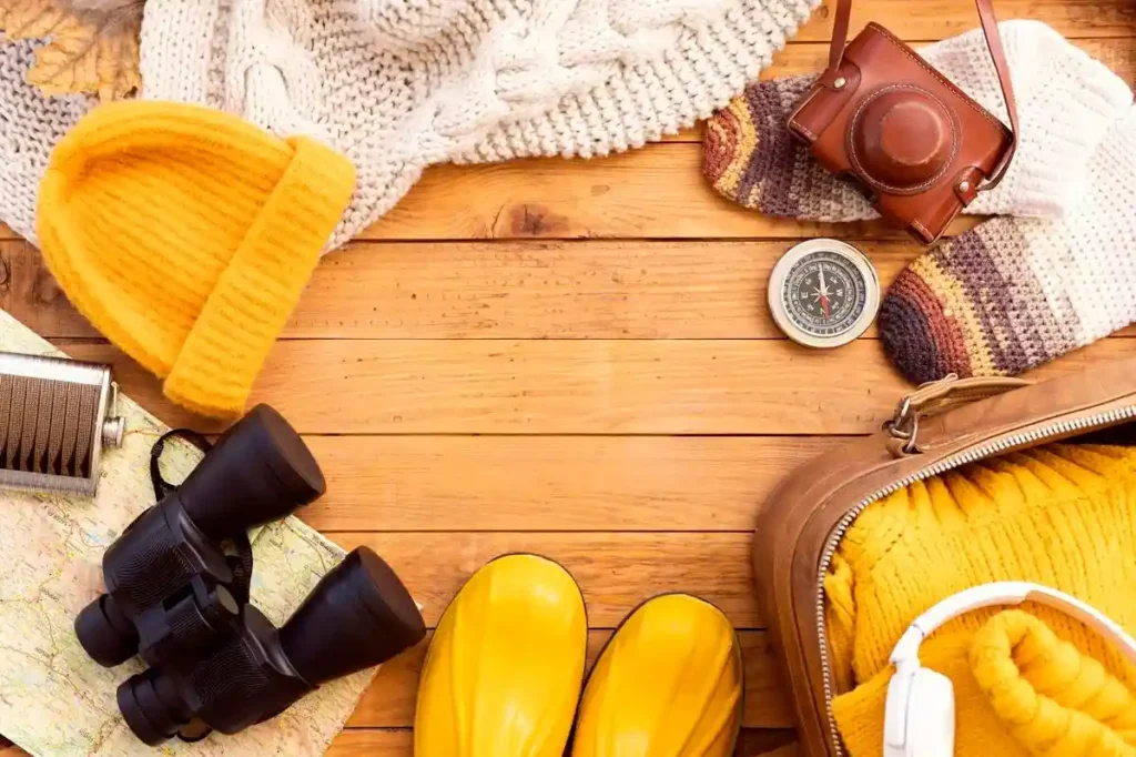 3.compressed_winter_packing_items Snow monkey Park Japan trip essentials — winter packing gear including boots, gloves, hat, camera, and map