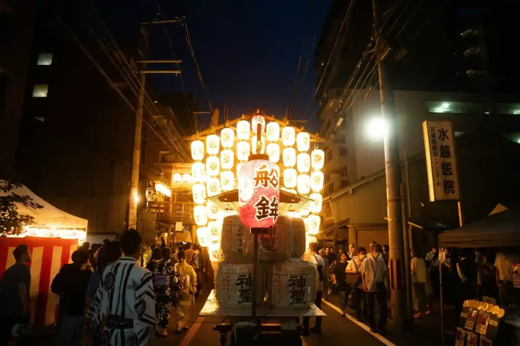 Dancers in traditional kimono performing under lantern lights during Owara Kaze no Bon, a graceful September festival in Japan