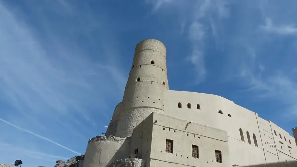 Bahla Fort’s iconic round tower under a bright blue sky – a must-visit historic site among the best things to do in Oman.

