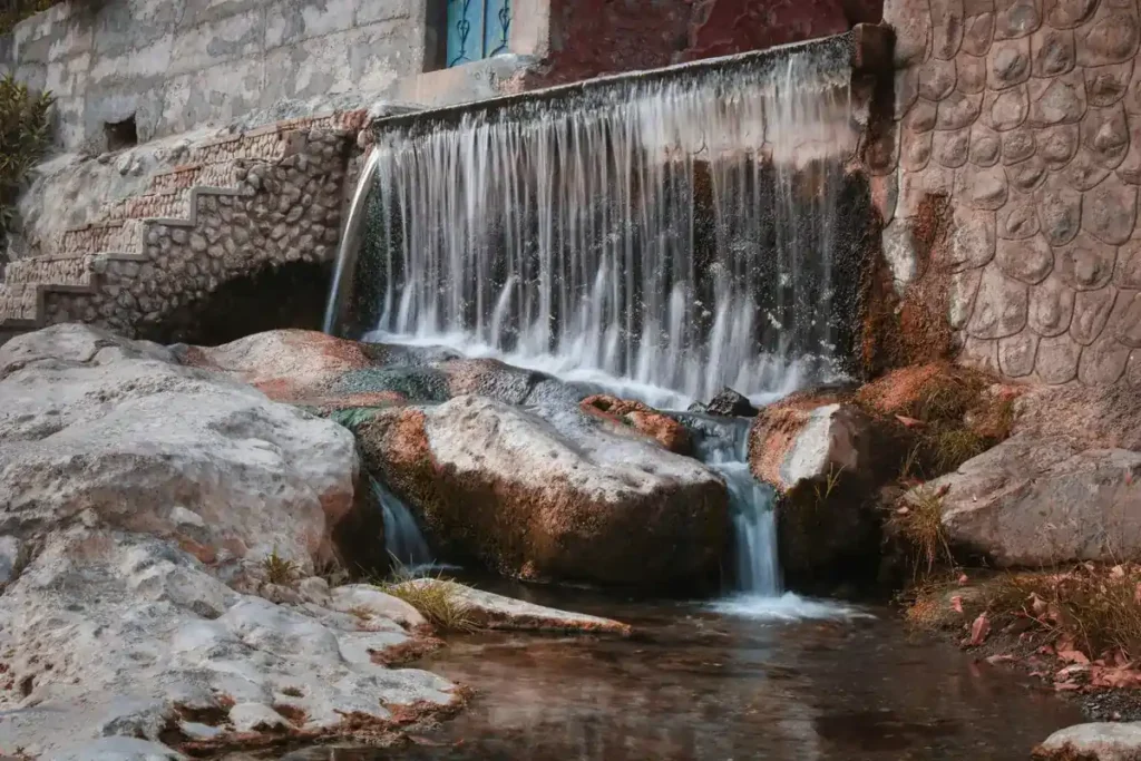 Rustaq hot spring waterfall flowing over natural stone – one of the best things to do in Oman for relaxation and wellness.